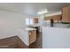 An inviting kitchen and dining area featuring stainless steel appliances, and a breakfast bar at 3405 W La Salle St, Phoenix, AZ 85041