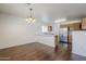 Open kitchen and dining area featuring wood floors, stainless steel appliances, and a breakfast bar at 3405 W La Salle St, Phoenix, AZ 85041