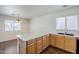 Bright kitchen with wood cabinets, quartz countertops, a stainless steel sink, and stainless appliances at 3405 W La Salle St, Phoenix, AZ 85041