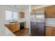Kitchen with stainless steel refrigerator and dark cabinets featuring quartz countertops at 3405 W La Salle St, Phoenix, AZ 85041