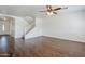 Open-concept living area featuring hardwood floors, stairs and view to entryway at 3405 W La Salle St, Phoenix, AZ 85041