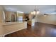 Open-concept living area with vinyl floors, and a view of the kitchen at 3405 W La Salle St, Phoenix, AZ 85041