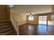 Bright living room with hardwood floors, neutral paint, and natural light from sliding glass door at 3405 W La Salle St, Phoenix, AZ 85041