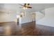 Open-concept living area featuring hardwood floors, stairs and view to kitchen at 3405 W La Salle St, Phoenix, AZ 85041