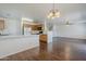 An open-concept living space seamlessly connects the kitchen, dining, and living areas with wood floors at 3405 W La Salle St, Phoenix, AZ 85041
