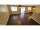 Spacious living room featuring wood-look flooring, neutral walls, and sliding doors to a patio or backyard at 3405 W La Salle St, Phoenix, AZ 85041