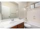 Bathroom featuring a shower-tub combo, mirror, wood-colored vanity, and toilet at 3477 E Sheffield Rd, Gilbert, AZ 85296