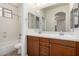Beautiful bathroom featuring double vanity, wood cabinets, and a shower-tub combo at 3477 E Sheffield Rd, Gilbert, AZ 85296