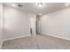 Neutral bedroom featuring carpet flooring, white walls, and an arched entrance to the ensuite bathroom at 3477 E Sheffield Rd, Gilbert, AZ 85296