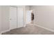 Carpeted bedroom featuring a closet, view of kitchen, and light-colored walls at 3477 E Sheffield Rd, Gilbert, AZ 85296