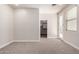Neutral bedroom featuring carpet flooring, white walls, and an entrance to the walk-in closet at 3477 E Sheffield Rd, Gilbert, AZ 85296