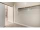 Walk-in closet featuring carpet flooring, white walls, and a wooden rack and shelf at 3477 E Sheffield Rd, Gilbert, AZ 85296