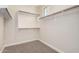 Walk-in closet featuring carpet flooring, white walls, and wooden racks and shelves at 3477 E Sheffield Rd, Gilbert, AZ 85296