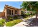 Inviting home showcasing a cozy front porch, lush landscaping, and convenient sidewalk access at 3477 E Sheffield Rd, Gilbert, AZ 85296