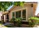 Beautiful home highlighting large windows, mature greenery, and a welcoming entrance at 3477 E Sheffield Rd, Gilbert, AZ 85296