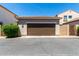 Exterior of garage with brown door and exterior wall and landscaping at 3477 E Sheffield Rd, Gilbert, AZ 85296
