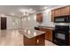 Bright open kitchen, granite island, black appliances and a large window to let in natural light at 3477 E Sheffield Rd, Gilbert, AZ 85296