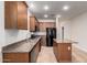 Spacious kitchen featuring granite countertops, stainless appliances, and wooden cabinets at 3477 E Sheffield Rd, Gilbert, AZ 85296