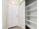 Well-lit walk-in pantry with ample shelving, located next to an exterior door at 3477 E Sheffield Rd, Gilbert, AZ 85296