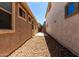 View of the side yard with desert landscaping and access gate at 3477 E Sheffield Rd, Gilbert, AZ 85296