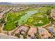 Aerial view showcasing homes near a beautiful golf course and scenic lake at 36298 N Crucillo Dr, Queen Creek, AZ 85140