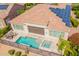 Aerial view showcases backyard oasis with pool, spa, outdoor kitchen, and covered patio at 36298 N Crucillo Dr, Queen Creek, AZ 85140
