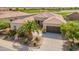 Aerial view of home featuring landscaping, a three car garage and desert views at 36298 N Crucillo Dr, Queen Creek, AZ 85140