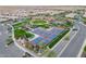 Aerial view of community amenities including tennis courts, pool, event center, green space and parking at 36298 N Crucillo Dr, Queen Creek, AZ 85140