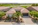 Aerial view of home featuring landscaping, a three car garage and desert views at 36298 N Crucillo Dr, Queen Creek, AZ 85140