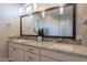 Bathroom featuring double sinks, granite countertop, tile backsplash, and a large mirror at 36298 N Crucillo Dr, Queen Creek, AZ 85140