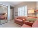 Charming bedroom with carpet flooring and pink accent chairs, with a view of the window at 36298 N Crucillo Dr, Queen Creek, AZ 85140