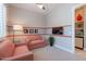 Inviting bedroom featuring soft pink armchairs, neutral carpeting, a red stripe, and a TV at 36298 N Crucillo Dr, Queen Creek, AZ 85140