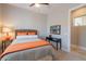Comfortable bedroom with a woven headboard, and accent furniture at 36298 N Crucillo Dr, Queen Creek, AZ 85140