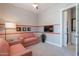 Cozy bedroom with a red stripe, comfortable armchairs, carpet flooring, and an ensuite bathroom at 36298 N Crucillo Dr, Queen Creek, AZ 85140