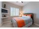 Comfortable bedroom with a woven headboard, plantation shutters, and built in shelving at 36298 N Crucillo Dr, Queen Creek, AZ 85140