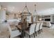 Elegant dining space featuring a large dining table that connects to the kitchen and living room at 36298 N Crucillo Dr, Queen Creek, AZ 85140