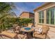Relaxing backyard seating area with a cozy round firepit and comfortable upholstered chairs at 36298 N Crucillo Dr, Queen Creek, AZ 85140