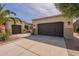 Exterior view of a home featuring two garages and desert landscaping at 36298 N Crucillo Dr, Queen Creek, AZ 85140