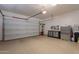 View of the spacious garage with epoxy flooring, ample storage, work bench, and garage door opener at 36298 N Crucillo Dr, Queen Creek, AZ 85140