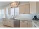 Kitchen shows stainless steel dishwasher, granite countertops, and white cabinets at 36298 N Crucillo Dr, Queen Creek, AZ 85140