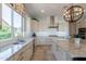 Spacious kitchen features a large island, stainless steel appliances, and modern lighting at 36298 N Crucillo Dr, Queen Creek, AZ 85140