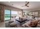 Well-lit living room with comfortable seating, a large sliding glass door, and an open floor plan at 36298 N Crucillo Dr, Queen Creek, AZ 85140