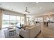 Open concept living room featuring tile floors, neutral furniture and golf course views at 36298 N Crucillo Dr, Queen Creek, AZ 85140