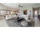 Bright, modern living room showcasing stylish furnishings, tile flooring, and an open layout to the kitchen at 36298 N Crucillo Dr, Queen Creek, AZ 85140