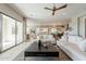 Open concept living room featuring tile floors, modern furniture, and a large sliding glass door at 36298 N Crucillo Dr, Queen Creek, AZ 85140