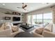 Inviting living room with ceiling fan, large sliding doors to the patio, and stylish furniture at 36298 N Crucillo Dr, Queen Creek, AZ 85140