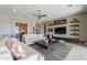 Contemporary living room featuring built-in shelving, comfortable seating, and a stylish coffee table at 36298 N Crucillo Dr, Queen Creek, AZ 85140