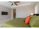 Bright main bedroom with tray ceiling and carpeted flooring plus walk-in closet at 36298 N Crucillo Dr, Queen Creek, AZ 85140