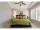 Spacious main bedroom featuring large windows with plantation shutters and a tray ceiling at 36298 N Crucillo Dr, Queen Creek, AZ 85140