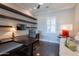 Stylish home office features a built-in desk, shelving, and wood flooring for a professional workspace at 36298 N Crucillo Dr, Queen Creek, AZ 85140